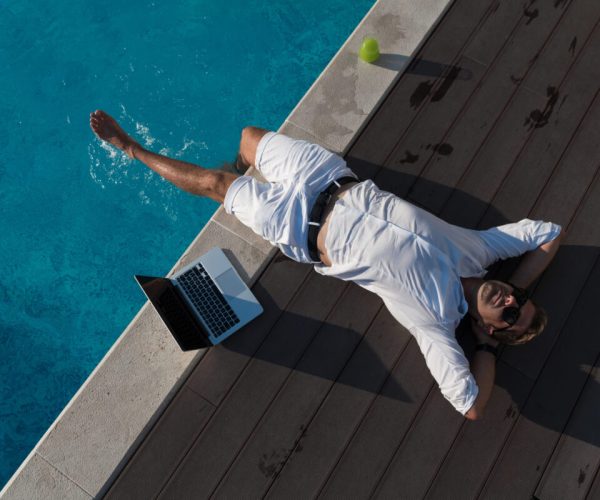 A modern senior man in casual clothes enjoys a vacation in an expensive house. Selective focus. High-quality photo